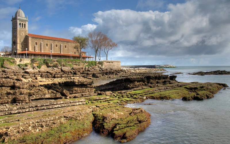 Vista de la iglesia de Santa María en Luanca cerca del mar